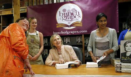 Hillary Clinton poses for a photo during a signing session for her book "Hard Choices" at the Bunch of Grapes bookstore in Vineyard Haven on Martha's Vineyard, Massachusetts August 13, 2014. REUTERS/Kevin Lamarque