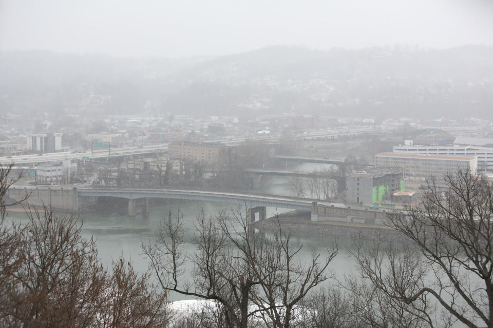 Snow falls over the confluence of the Elk and Kanawha Rivers, Sunday, March 16, 2014, in Charleston, W.Va. (AP Photo/Charleston Daily Mail, Marcus Constantino)