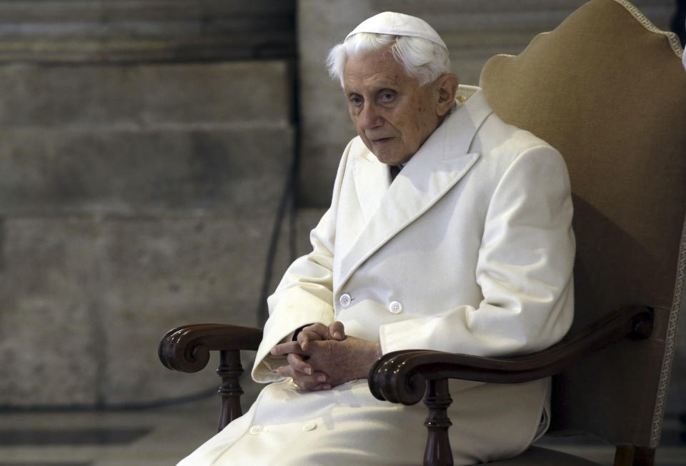 FILE - Pope Emeritus Benedict XVI sits in St. Peter's Basilica as he attends the ceremony marking the start of the Holy Year, at the Vatican, Dec. 8, 2015. The Vatican next year will publish a collection of private homilies delivered by the late Pope Benedict XVI for his Sunday Masses, most of them penned during his 10-year retirement, officials said Saturday, Dec. 23, 2023. (AP Photo/Gregorio Borgia, File)