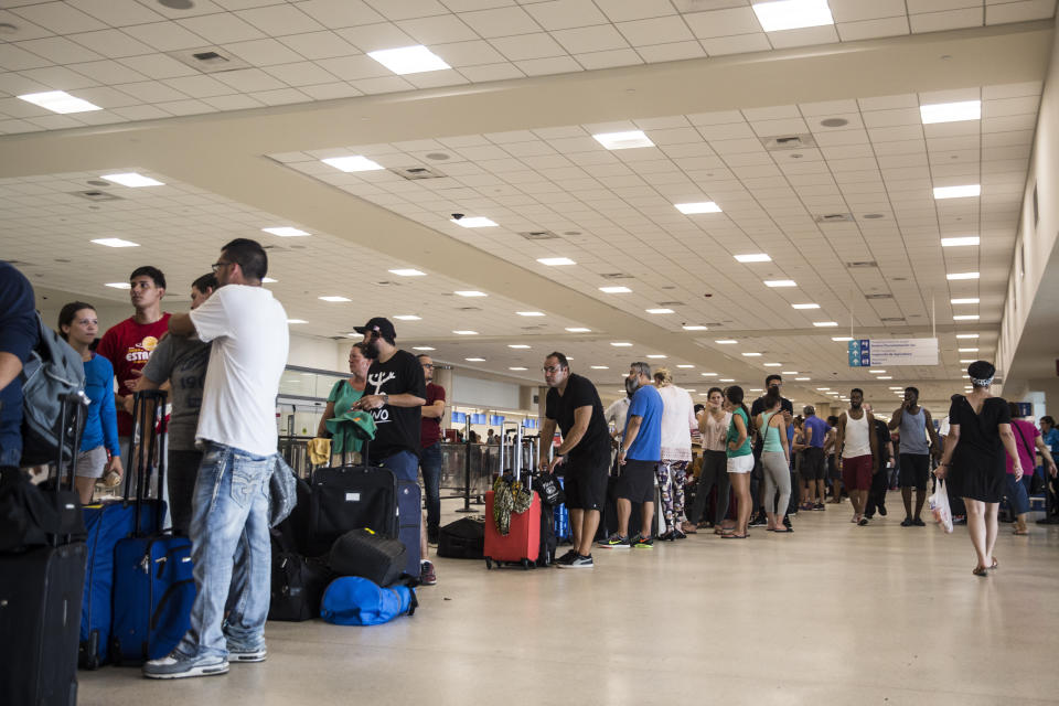 Travelers stand in line at Luis Muoz Marn International Airport in San Juan, Puerto Rico, on Monday. (Photo: Bloomberg via Getty Images)