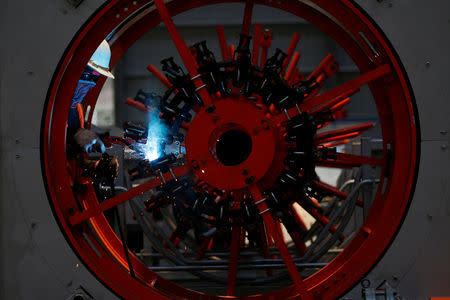 A worker welds as he installs bore-pile devices at a steel fabrication of rebar cages site for Jakarta-Bandung High Speed Railway in West Bandung regency, West Java province, Indonesia, February 21, 2019. REUTERS/Willy Kurniawan