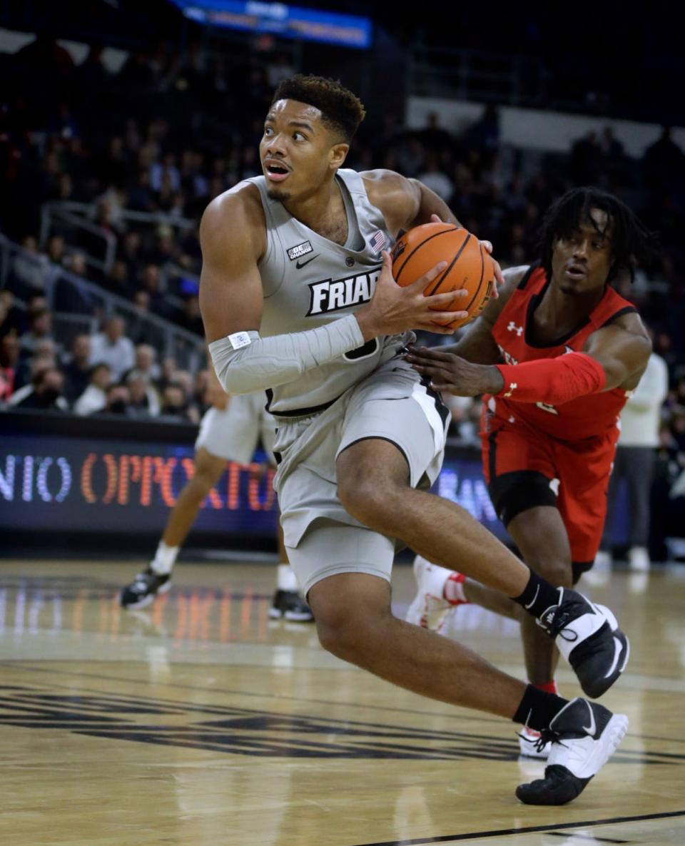 Providence College forward Ed Croswell drives to the basket and away from Texas Tech defender Davion Warren Wednesday night at the Dunkin' Donuts Center.