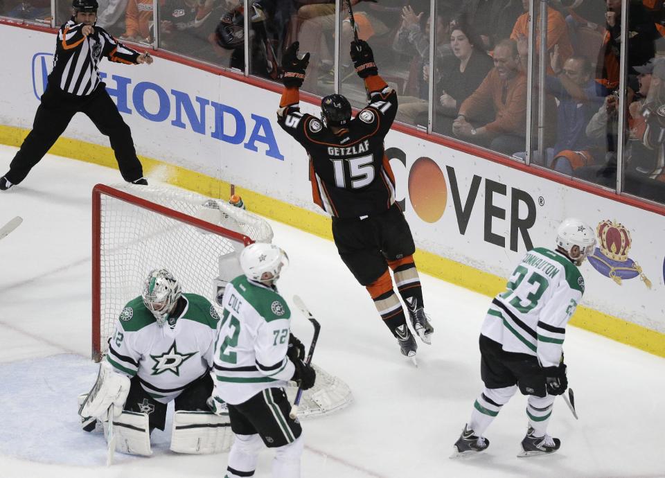 Anaheim Ducks' Ryan Getzlaf(15) celebrates his goal as he skates near Dallas Stars' Kari Lehtonen (32), of Finland; Erik Cole (72); and Kevin Connauton (23) during the first period in Game 2 of the first-round NHL hockey Stanley Cup playoff series on Friday, April 18, 2014, in Anaheim, Calif. (AP Photo/Jae C. Hong)