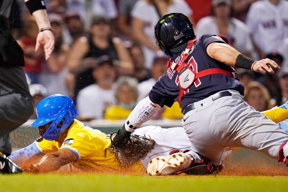 Guardians catcher Austin Hedges, right, tags out Boston Red Sox shortstop Xander Bogaerts, who was trying to score on a fly out by Kevin Plawecki in the third inning of Tuesday night's game at Fenway Park. The Guardians won 8-3. [Charles Krupa/Associated Press]