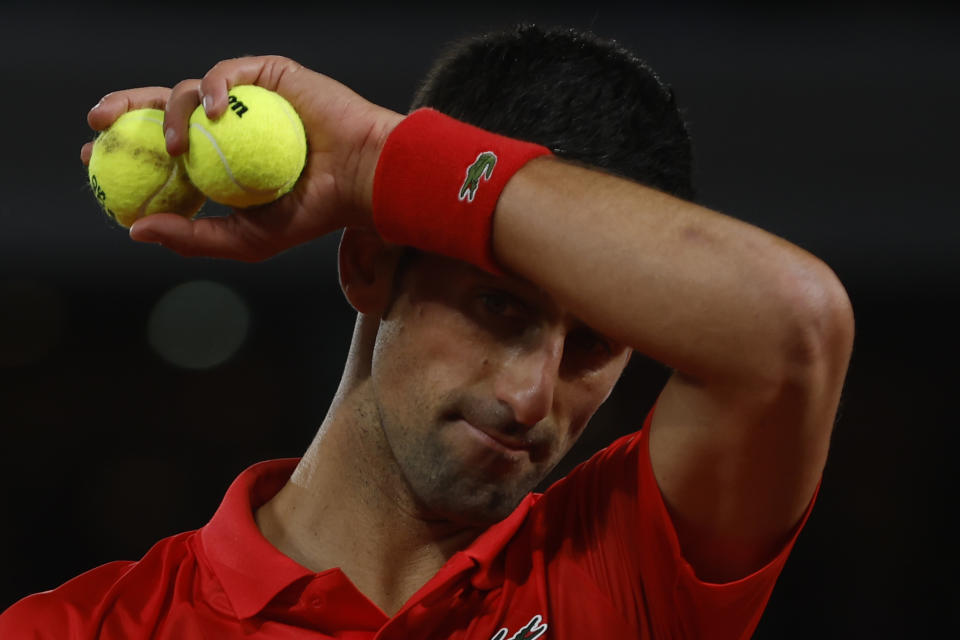 Serbia's Novak Djokovic wipers his forehead as he plays Spain's Rafael Nadal during their quarterfinal match of the French Open tennis tournament at the Roland Garros stadium Tuesday, May 31, 2022 in Paris. (AP Photo/Jean-Francois Badias)