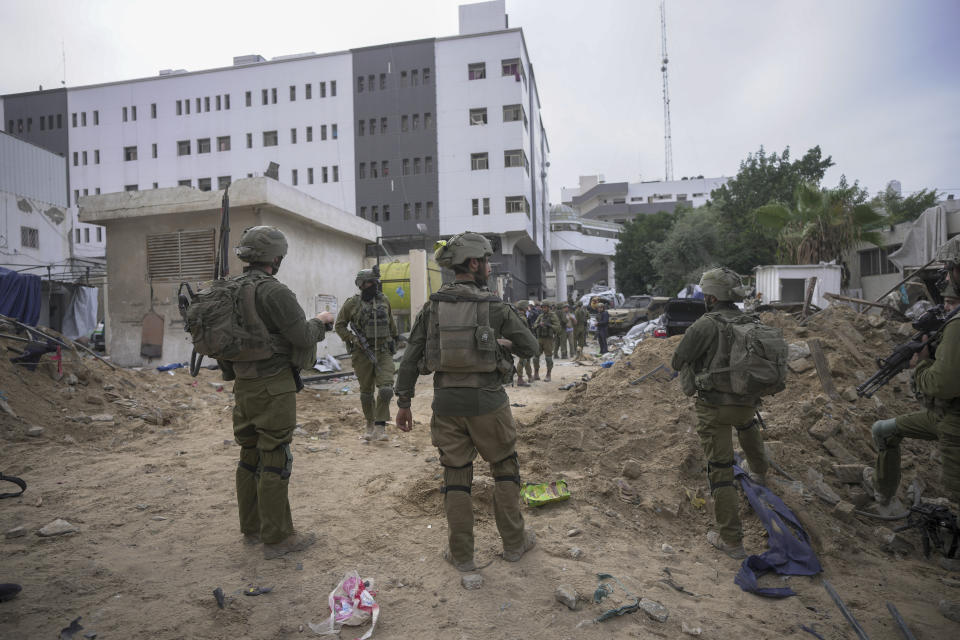 Israeli soldiers stand outside Shifa Hospital in Gaza City, Wednesday, Nov. 22, 2023. Israel says that Hamas militants sought cover on the grounds of the hospital and used the tunnel for military purposes. (AP Photo/Victor R. Caivano)