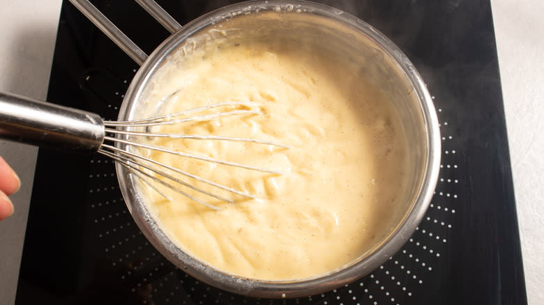 Whisking an egg custard in a saucepan