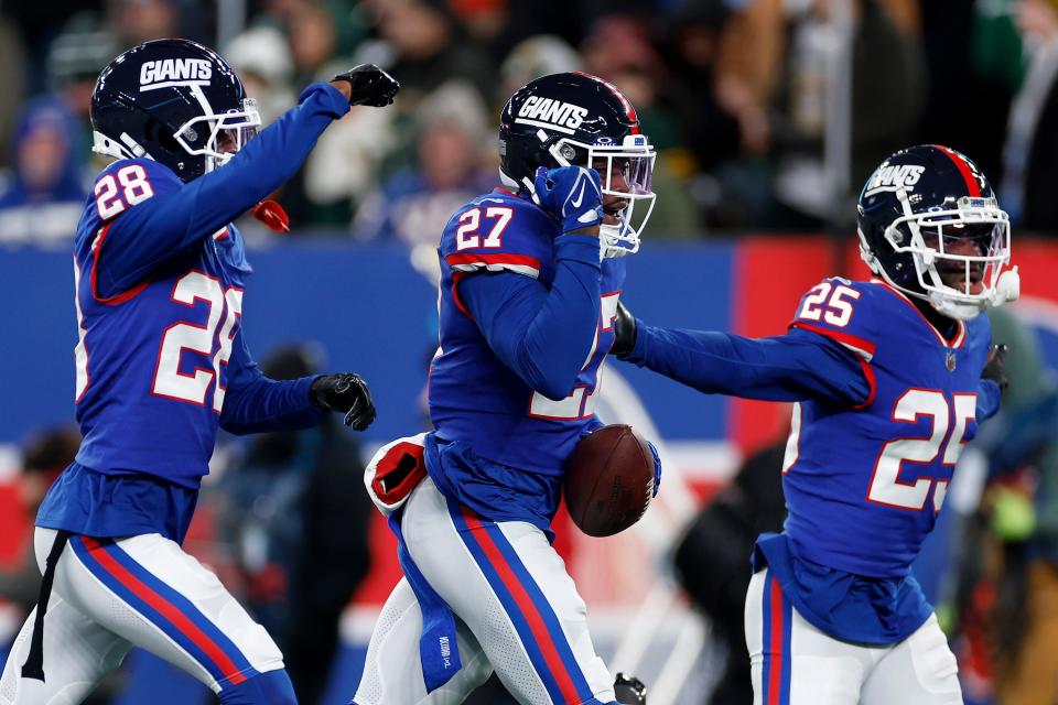 EAST RUTHERFORD, NEW JERSEY - DECEMBER 11: Jason Pinnock #27 of the New York Giants celebrates with his teammates after intercepting a pass thrown by Jordan Love #10 of the Green Bay Packers during the second quarter in the game at MetLife Stadium on December 11, 2023 in East Rutherford, New Jersey. (Photo by Sarah Stier/Getty Images)