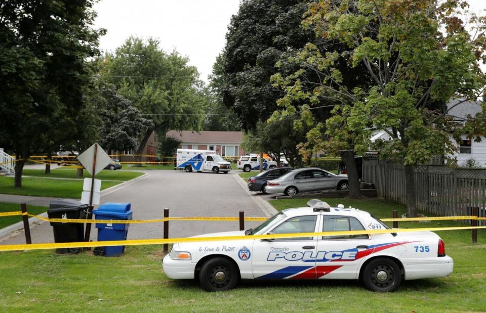 Toronto police cordon off the area outside the house where Brett Ryan killed his mother and two of his brothers (Reuters)