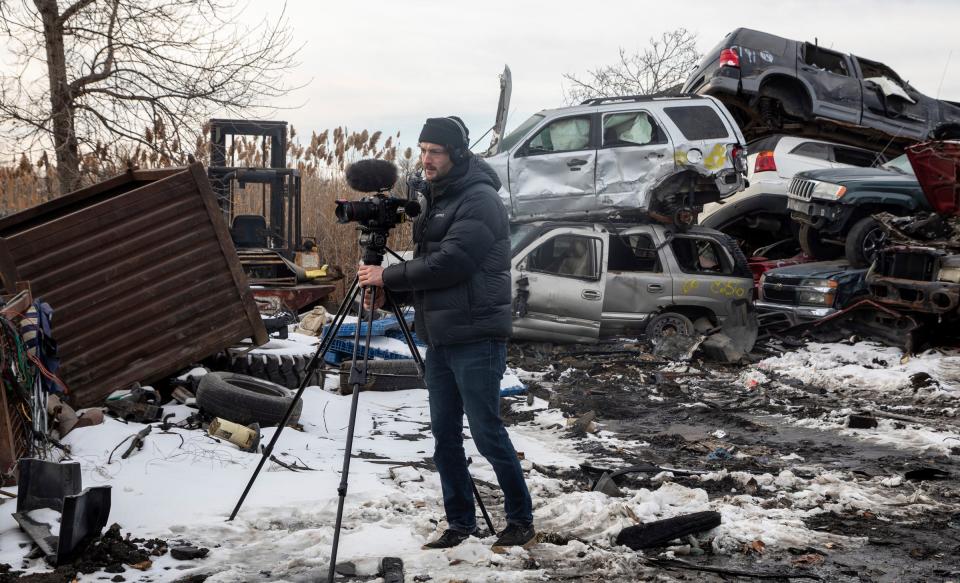 Dorian Degoutte, 31, a filmmaker from Vierzon, France, records footage for his art film inside Pal's Auto Parts in Detroit on Dec. 28, 2022.