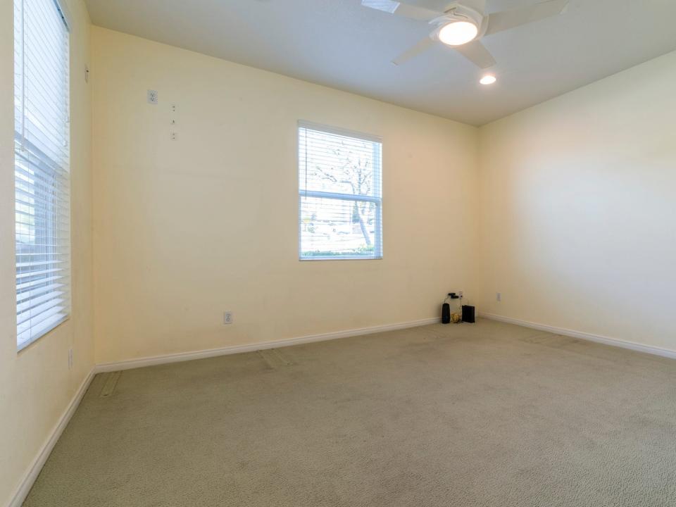 A yellow room with gray flooring.