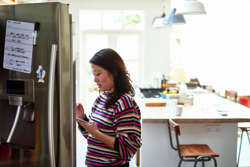 woman in front of an open fridge