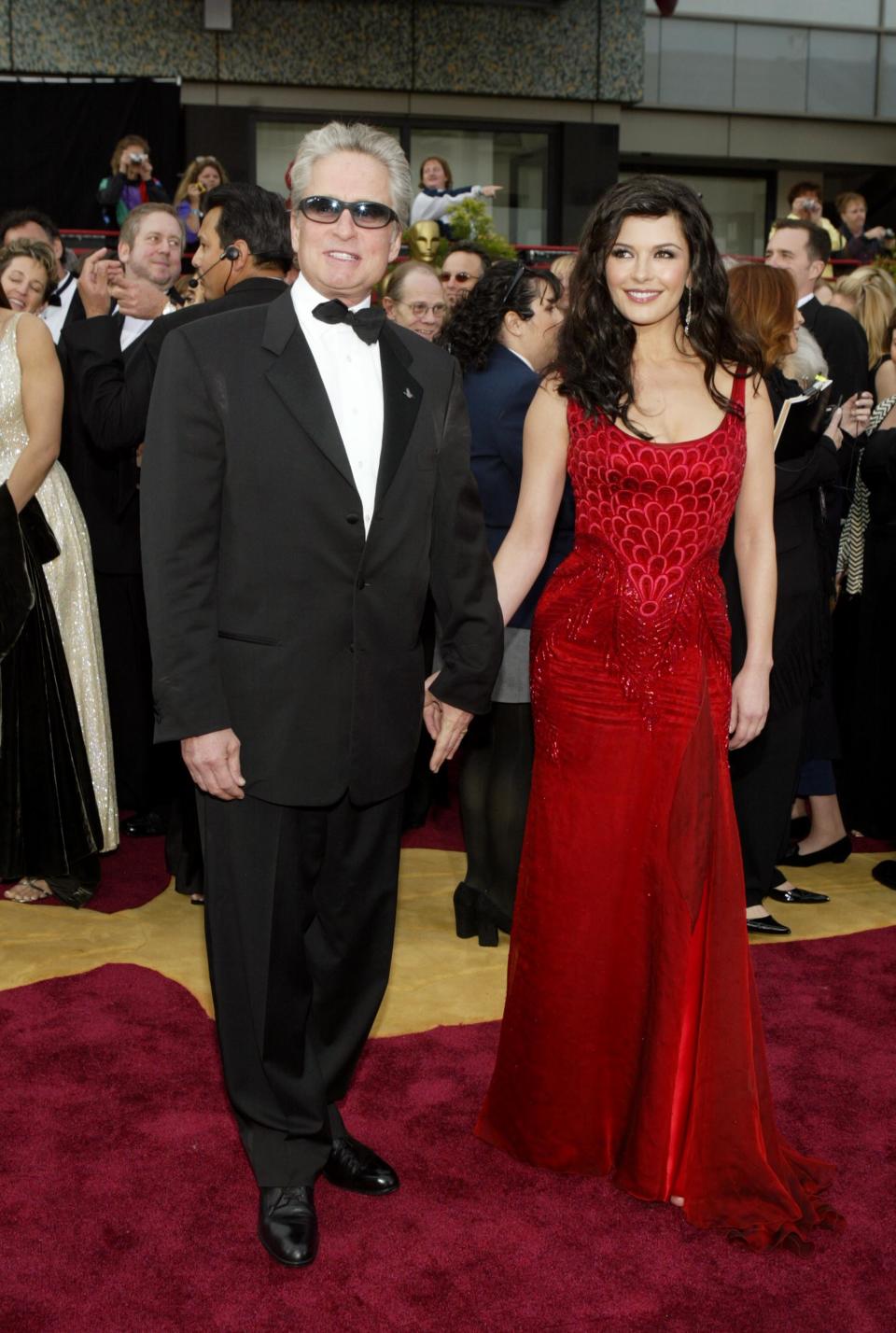 Michael Douglas in a tuxedo and Catherine Zeta-Jones in a red gown.