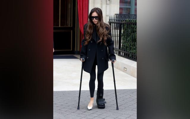 Victoria Beckham matches crutches to her outfit at Paris Fashion Week