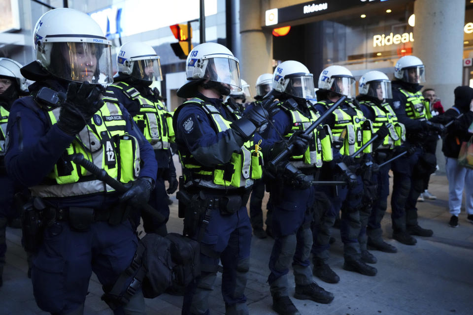 Police don crowd control equipment during a demonstration, part of a convoy-style protest participants are calling "Rolling Thunder", Friday, April 29, 2022, in Ottawa. (Sean Kilpatrick/The Canadian Press via AP)