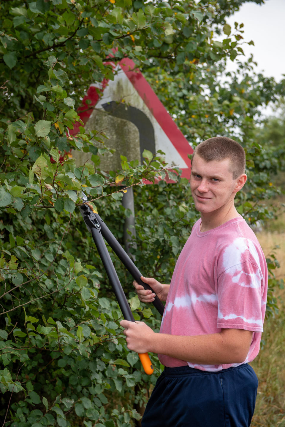 A teenage boy annoyed by road signs left dirty and hedges overgrown during lockdown has become a local hero after going on a mission to clean them all up. Joseph Beer, 15, noticed dozens of neglected street signs and hedgerows whilst out on his daily walks with mum Lisa, 52. He soon decided he wanted to clean up the streets - and with the help of dad Mark, 56, he rigged up a trailer to fix to the back of his bike, and started peddling around the streets near his house. Almost every day, Joseph, from Chatteris, Cambs., has headed off on his bike, towing a bucket of soapy water, some sponges, and garden tools, including hedgecutters and a rake, in the trailer.

His efforts have seen him clean up street name signs that have been left almost unreadable due to moss growing over them, such as Wilburton Road in nearby Ely.