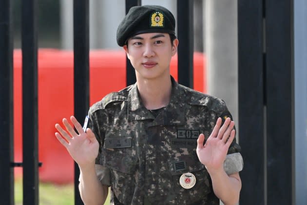 Jin waves after being discharged from his mandatory military service outside a military base on June 12, 2024.  - Credit: JUNG YEON-JE/AFP/Getty Images 