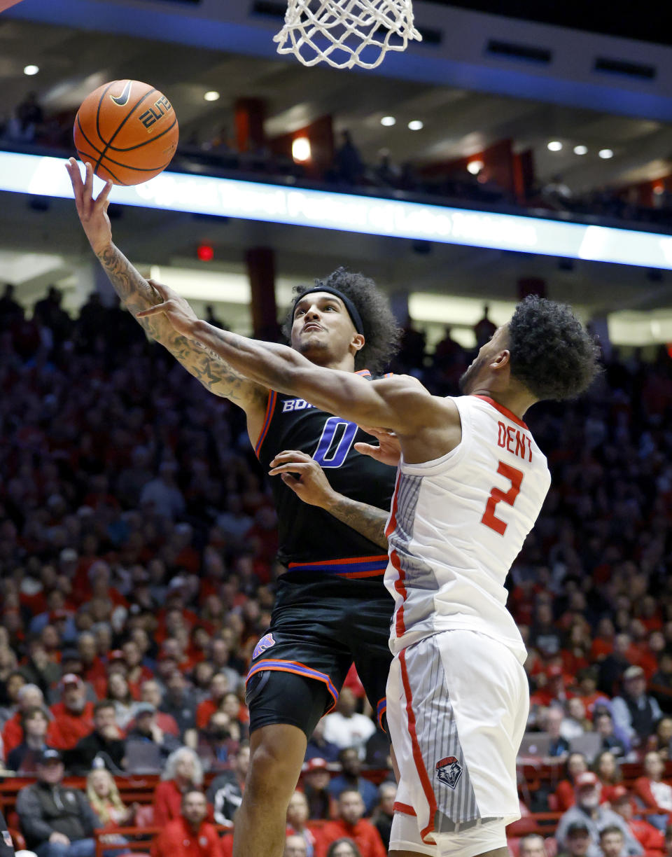 Boise State guard Roddie Anderson III is fouled on a layup attempt by New Mexico guard Donovan Dent during the first half of an NCAA college basketball game, Wednesday, Jan. 31, 2024, in Albuquerque, N.M. (AP Photo/Eric Draper)