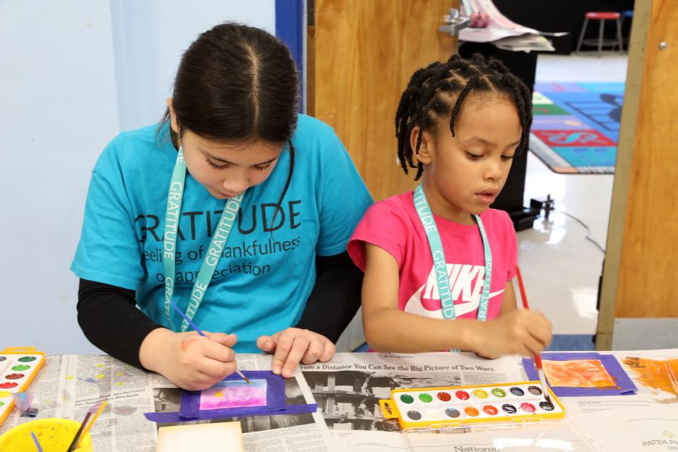 Fourth-grader Chloe Rudner, left, and kindergartener Saniya Simpson, who are in the house of Gratitude, paint pictures for their gratitude boxes at Carrie E. Tompkins Elementary School in Croton Nov. 17, 2023. Students in grades K-4 are divided into eight groups or "houses" and once a month they come together to work on different projects together.