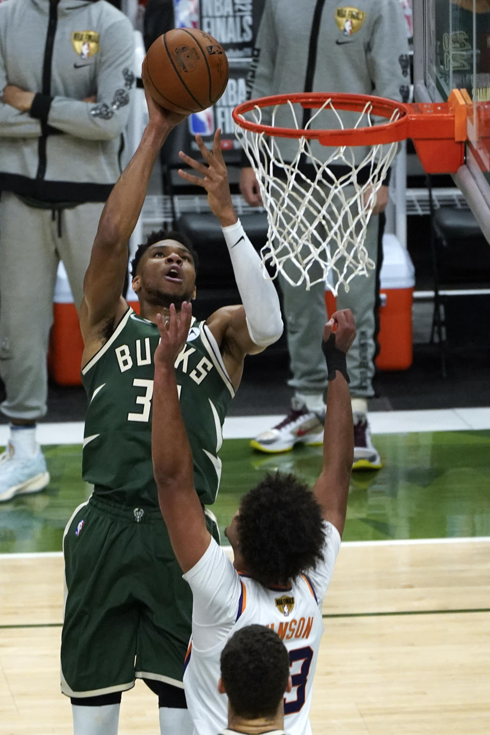 Milwaukee Bucks forward Thanasis Antetokounmpo (43) shoots on Phoenix Suns forward Cameron Johnson (23) during the second half of Game 3 of basketball's NBA Finals in Milwaukee, Sunday, July 11, 2021. (AP Photo/Paul Sancya)