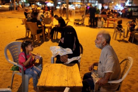 Palestinian family sits in an outdoor rest area in Khan Younis in the southern Gaza Strip