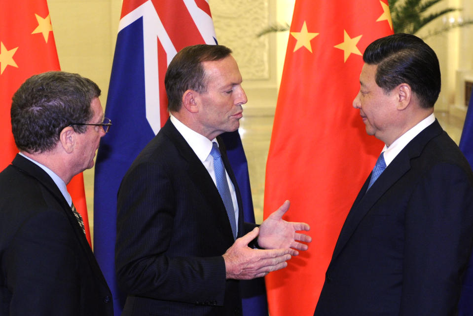 Australian Prime Minister Tony Abbott, speaks to Chinese President Xi Jinping, right, before a meeting at the Great Hall of the People in Beijing Friday, April 11, 2014. (AP Photo/Parker Song, Pool)