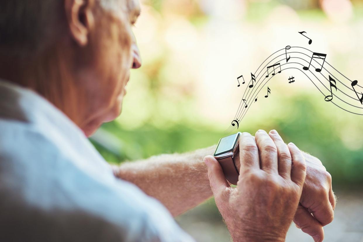 An older man looking at his Apple Watch as musical notes emit from it.