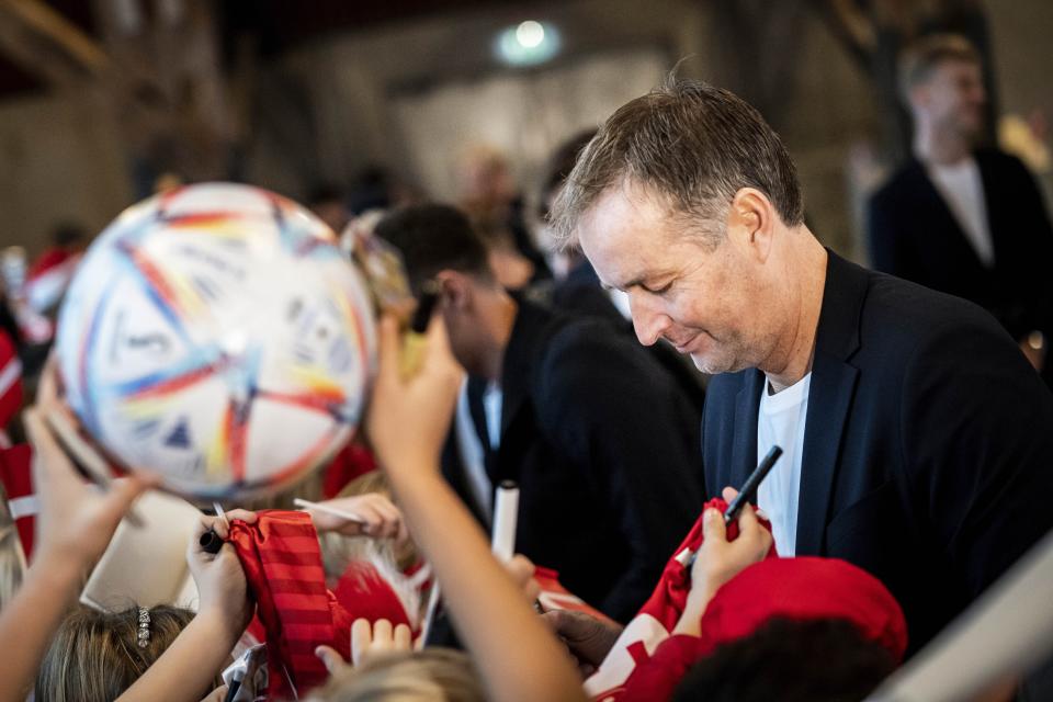 Denmark's head coach Kasper Hjulmand signs autographs for elementary school children Tuesday during an event to send the national soccer team off on their journey to the World Cup in Qatar.