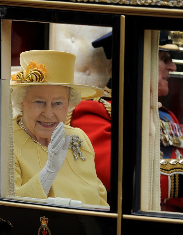 FILE PHOTO: Britain's Queen Elizabeth and Prince Philip travel to Buckingham Palace in Semi-State Landau along Procession Route after wedding of Prince William and Kate Middleton in Westminster Abbey in London