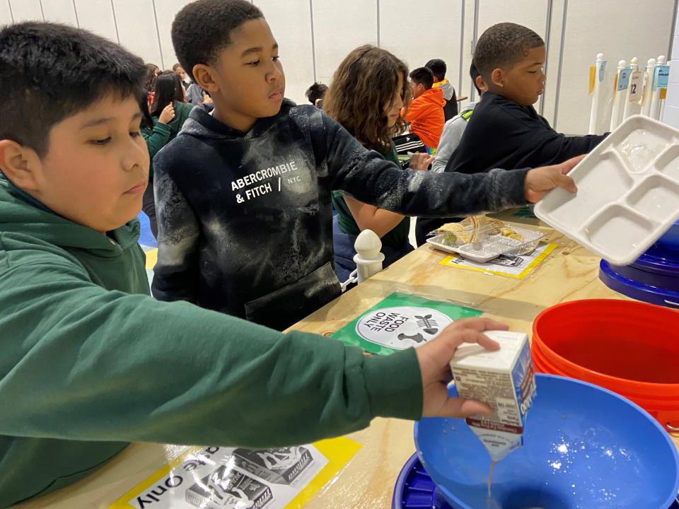 Students at George L. Catrambone Elementary School  sort food at lunch to go into the compost machine.