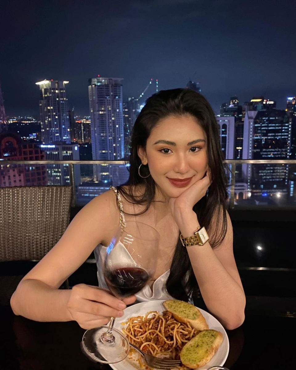 Christine Angelica Dacera eating dinner on a roof top bar. Source: Newsflash/Australscope
