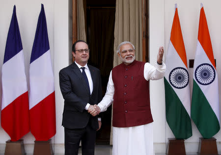 French President Francois Hollande (L) shakes hands with Prime Minister Narendra Modi during a photo opportunity ahead of their meeting at Hyderabad House in New Delhi, January 25, 2016. REUTERS/Adnan Abidi/Files