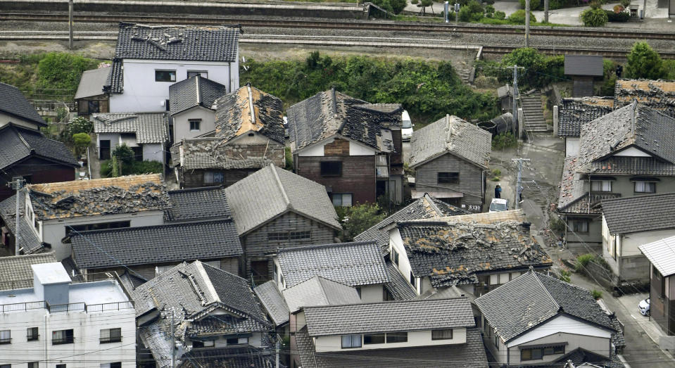 This aerial view shows damaged roof tiles of residential houses in Tsuruoka, Yamagata prefecture, northwestern Japan, Wednesday, June 19, 2019, after an earthquake. The powerful earthquake jolted northwestern Japan late Tuesday, prompting officials to issue a tsunami warning along the coast which was lifted about 2 ½ hours later. Tsuruoka city officials were helping coastal residents evacuate to higher ground as a precaution. (Kyodo News via AP)
