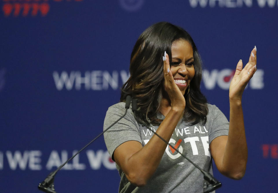 Former first lady Michelle Obama claps as she speaks at a rally to encourage voter registration on Friday, Sept. 28, 2018, in Coral Gables, Fla. (AP Photo/Brynn Anderson)