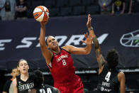 Las Vegas Aces' Liz Cambage (8) tries to get a shot off as Seattle Storm's Candice Dupree (4) defends in the first half of a WNBA basketball game Saturday, May 15, 2021, in Everett, Wash. (AP Photo/Elaine Thompson)
