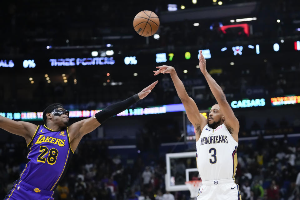 New Orleans Pelicans guard CJ McCollum (3) shoots against Los Angeles Lakers forward Rui Hachimura (28) in the first half of an NBA basketball game in New Orleans, Sunday, Dec. 31, 2023. (AP Photo/Gerald Herbert)