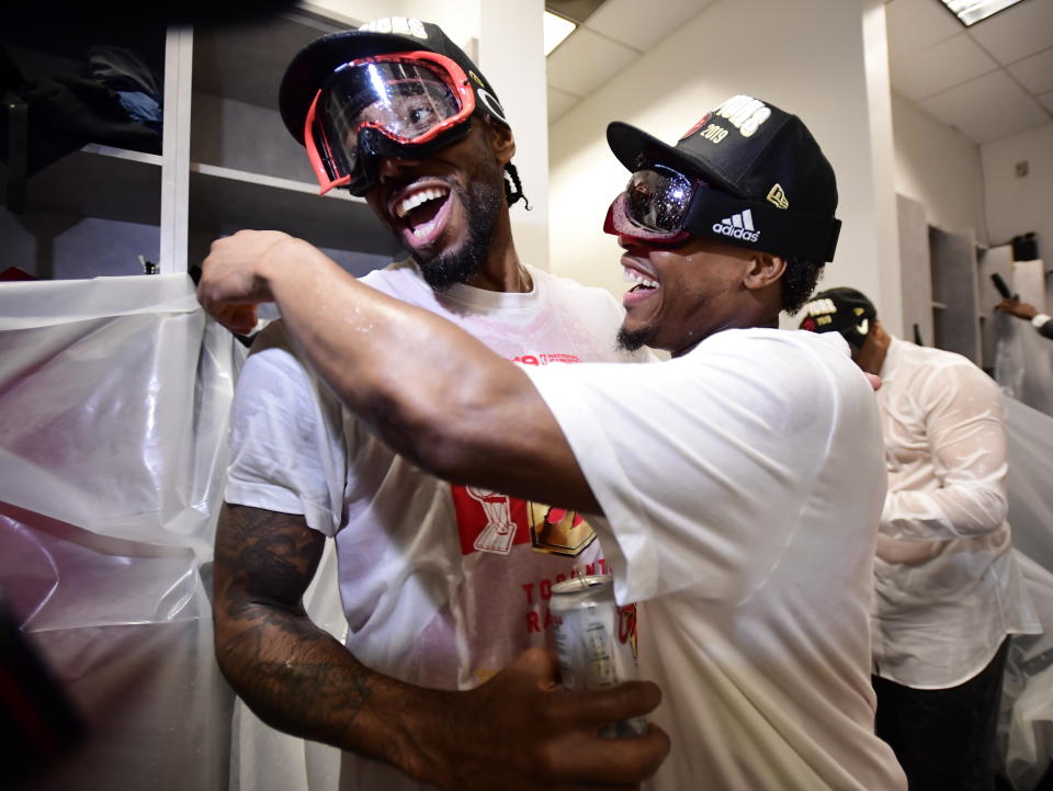 Toronto Raptors' Kawhi Leonard, left, and Kyle Lowry celebrate in the locker room after the Raptors' 114-110 win over the Golden State Warriors in Game 6 of basketball’s NBA Finals, Thursday, June 13, 2019, in Oakland, Calif. (Frank Gunn/The Canadian Press via AP)