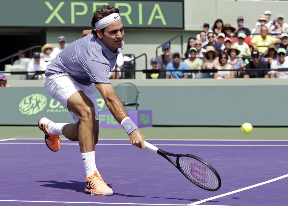 Roger Federer, of Switzerland, returns to Thiemo de Bakker, of the Netherlands, at the Sony Open tennis tournament in Key Biscayne, Fla., Sunday, March 23, 2014. (AP Photo/Alan Diaz)