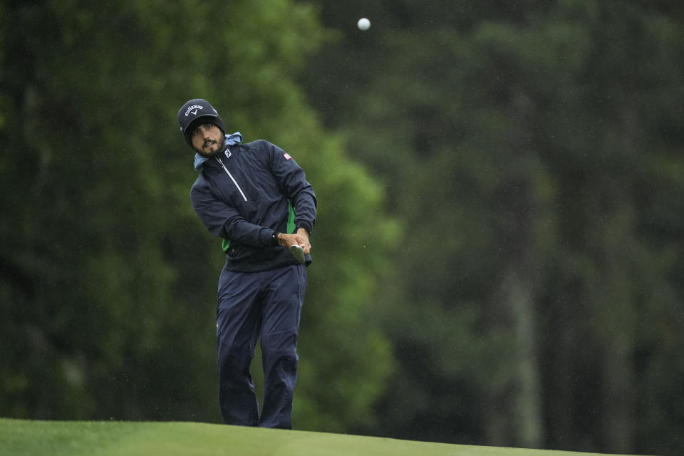 Abraham Ancer, of Mexico, chips to the green on the 18th hole during the weather delayed second round of the Masters golf tournament at Augusta National Golf Club on Saturday, April 8, 2023, in Augusta, Ga. (AP Photo/Charlie Riedel)