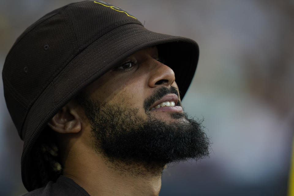 The San Diego Padres' Fernando Tatis Jr reacts in the dugout before the first inning of a baseball game against the Colorado Rockies, Monday, Aug. 1, 2022, in San Diego. (AP Photo/Gregory Bull)