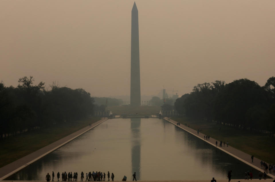Smoke from wildfires in Canada shrouds the Lincoln Memorial Reflecting Pool and the National Mall.