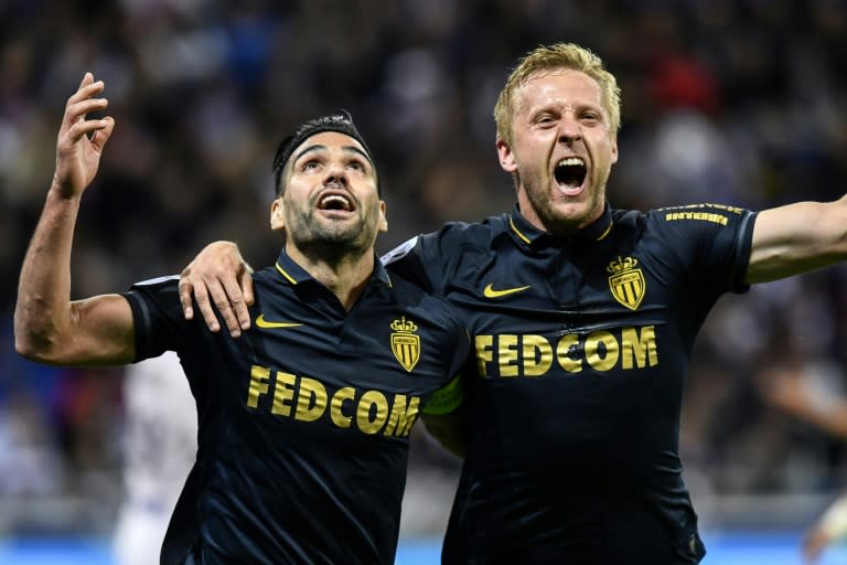 Monaco's Radamel Falcao (L) celebrates with teammate Kamil Glik after scoring a goal during their French Ligue 1 match against Olympique Lyonnais, in Decines-Charpieu, on April 23, 2017