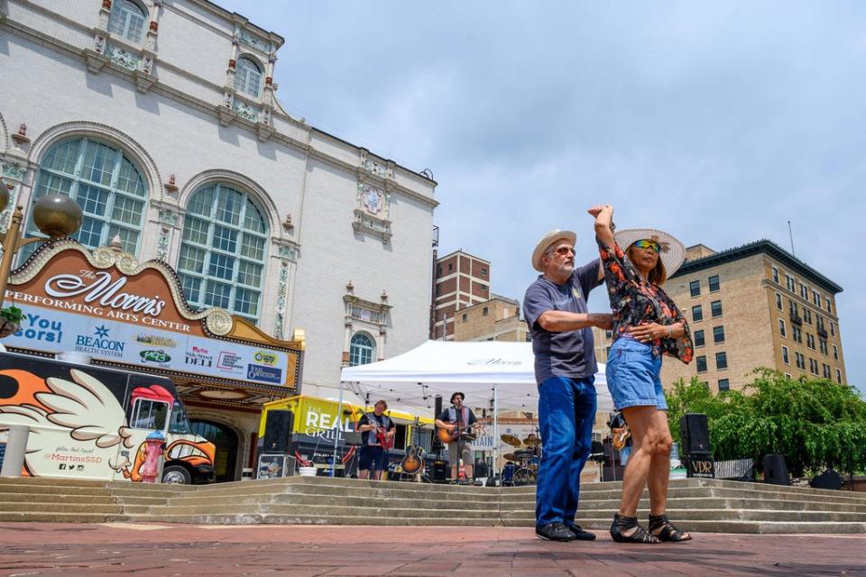 Robert Pinter and Dao Mikel dance to the music of the Van Dyke Revue at the John R. Hunt Plaza in South Bend during the Fridays by the Fountain event.