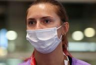 FILE PHOTO: Belarusian athlete Krystsina Tsimanouskaya is seen at Haneda international airport in Tokyo