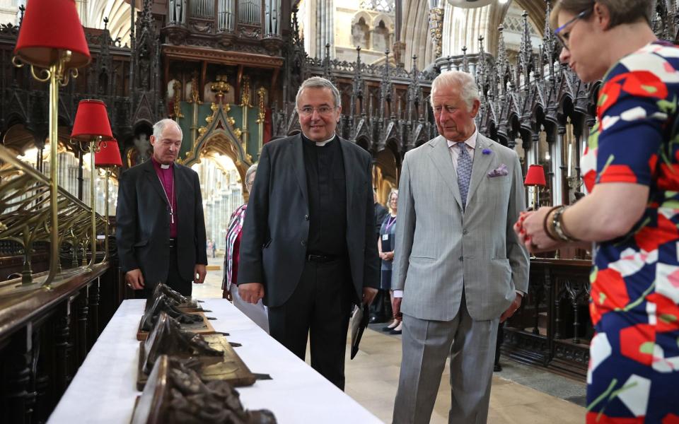 Prince Charles examines some of the cathedral's historic treasures with the Very Reverend Jonathan Greener, the Dean of Exeter - Chris Jackson/WPA Pool/Getty Images