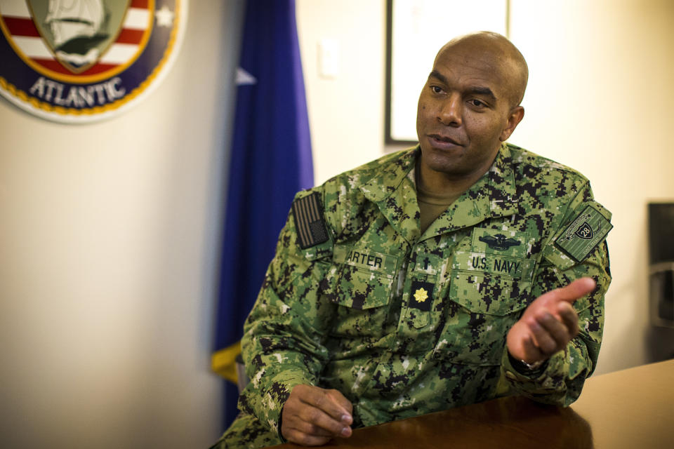 Navy Chaplain Lt. Cmdr. Madison Carter, the head chaplain for Destroyer Squadron 28, home ported at Norfolk Naval Station in Norfolk, Va. speaks about his role as a Navy chaplain on Tuesday, March 14, 2023. Carter, a Baptist pastor, says the vast majority of his talks with sailors involve not faith but life struggles that can make them feel unfulfilled and lose focus. “How do I make sure that you have mind, body and soul all locked in?” is the question that drives his mission. (AP Photo/John C. Clark)