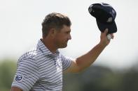 Bryson DeChambeau waves after his first round at the Masters golf tournament at Augusta National Golf Club Thursday, April 11, 2024, in Augusta, Ga. (AP Photo/Charlie Riedel)