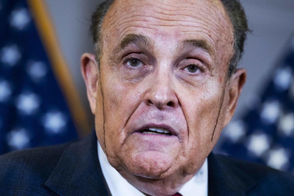 Rudy Giuliani at a news conference in November 2020 as hair dye appeared to streak down his face, an image that was frequently circulated as he tried to reverse the 2020 election results.  (Tom Williams / CQ Roll Call via AP file)