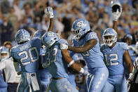 North Carolina linebacker Desmond Evans (10) congratulates linebacker Cedric Gray (33) after Gray's interception near the end of the second half of an NCAA college football game against Miami in Chapel Hill, N.C., Saturday, Oct. 16, 2021. (AP Photo/Gerry Broome)