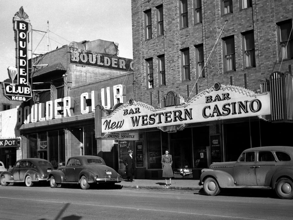A woman stands in front of New Western Casino and Boulder Club on Fremont Avenue in Las Vegas, Nevada